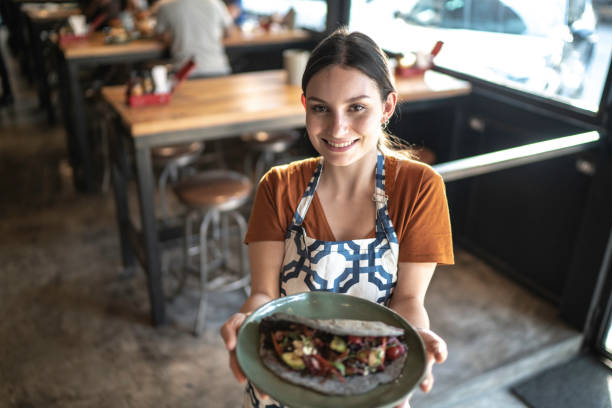 istock Waitress holding / showing a sandwich 1174706199
