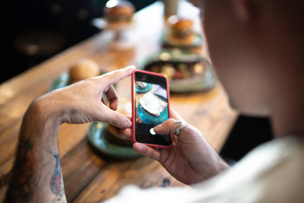 istock Influencer man filming the hamburger table 1174706206