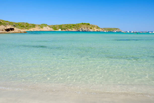 View on the sea with crystal water on the beach Es Grau on Menorca.