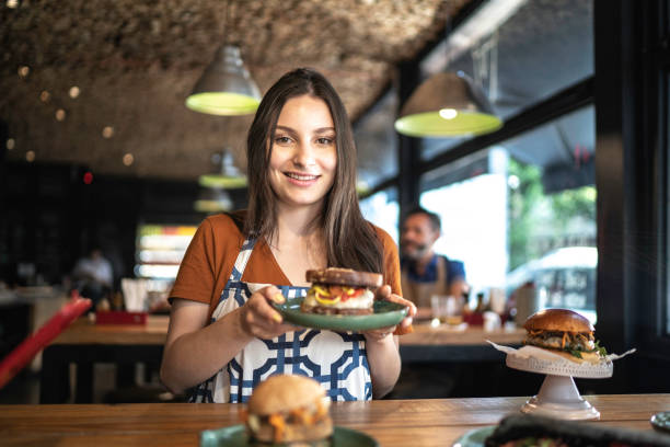 istock Waitress holding / showing a sandwich 1174707101