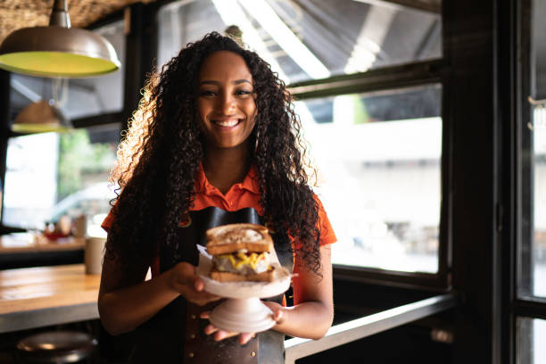 istock Waitress holding / showing a sandwich 1174707992