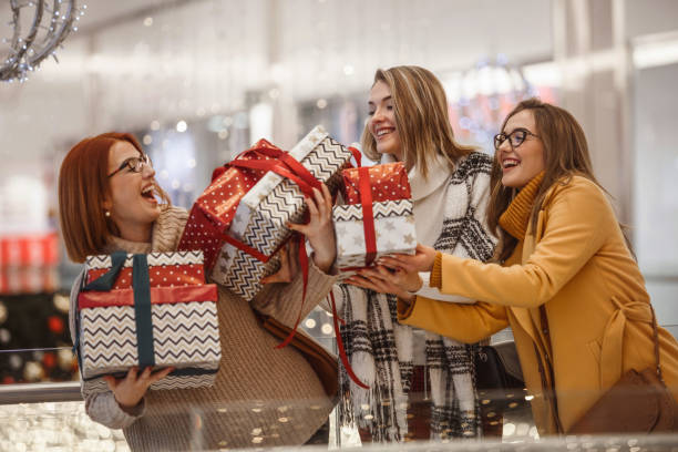 istock Mother and daughters having fun during Christmas shopping 1174711909