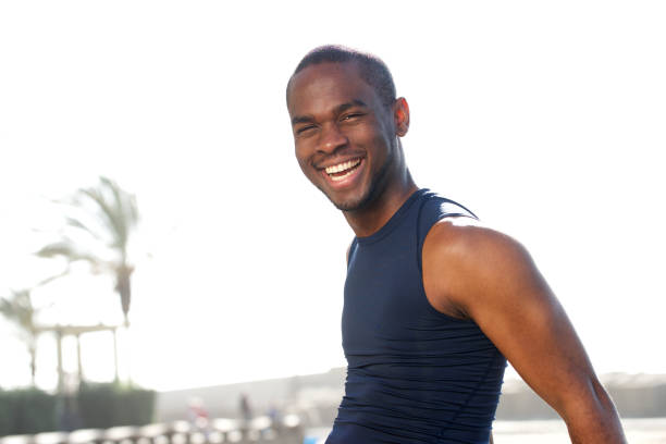 istock young black sports man smiling outside 1174711991