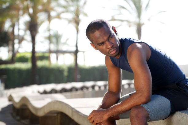 istock sporty young black man sitting outside 1174712008