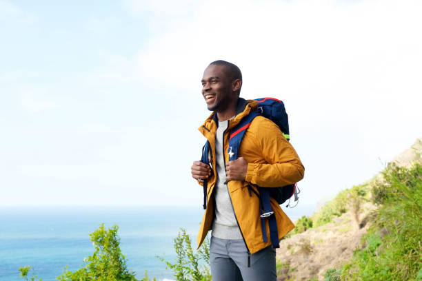 istock happy african american man with backpack outdoors 1174712557