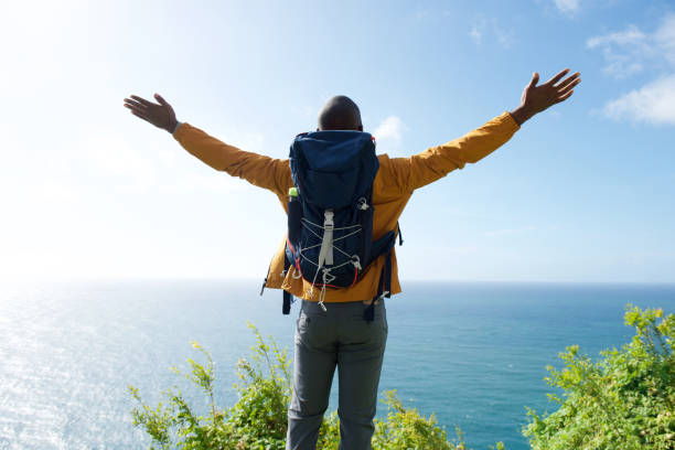 istock male hiker with arms spread open 1174712567