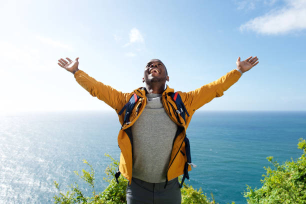 istock african american male hiker with backpack and arms open 1174712581