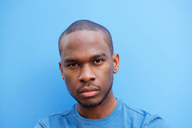 istock Close up cool young black man against blue background 1174712644