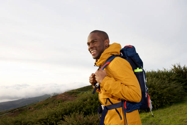 istock happy male backpacker walking in nature with bag 1174712684