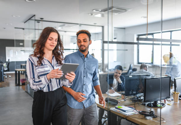 istock African and Caucasian Businesspeople Walking Through Office 1174712925