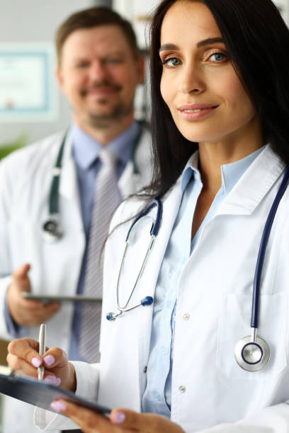 istock Group of smiling GP standing in office in line 1174713067