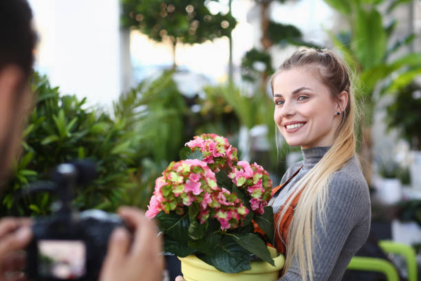 istock Happy Vlogger Posing with Flower to Camera Man 1174713096