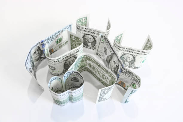 istock American currency - one-dollar and hundred-dollar bills stand on a surface. 1174713382