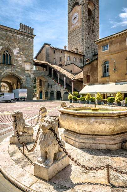Bergamo in summer, Italy Bergamo in summer, Italy. Piazza Vecchia in Citta Alta or Upper City. Lion statues with chains at the vintage fountain in the ancient Bergamo center. Antique architecture of Old town of Bergamo. bergamo stock pictures, royalty-free photos & images