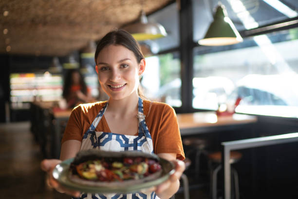 istock Waitress holding / showing a sandwich 1174719120