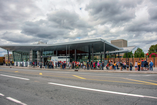 Ottawa, Canada - September 14, 2019:  A crowd of people wait in line to get on the long and eagerly awaited Confederation Line of the city