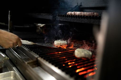 Male hands preparing a hamburger