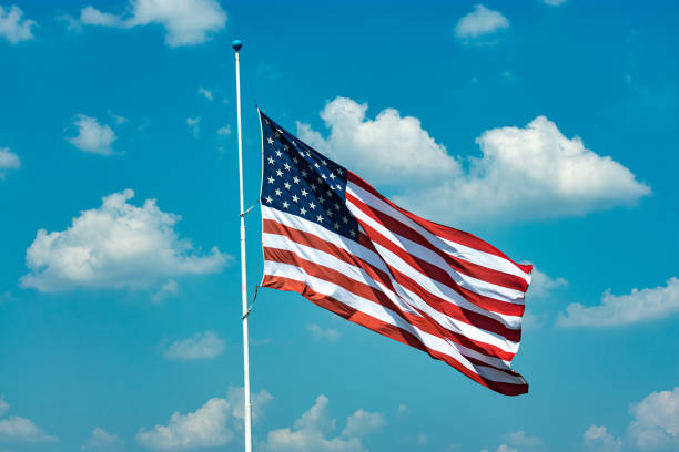 istock United States flag in blue sky 1174720358