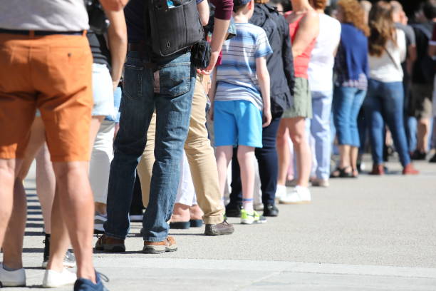 Long queue of people waiting in line stock photo