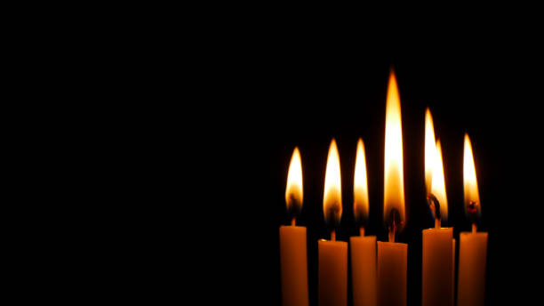 istock Blurred candles light on black halloween background. 1174725219