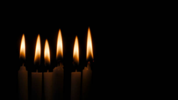 istock Blurred candles light on black halloween background. 1174725220