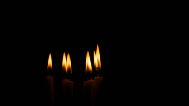 istock Blurred candles light on black halloween background. 1174725250