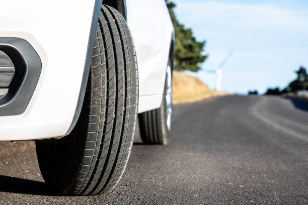 istock Closeup white car on the road 1174734136