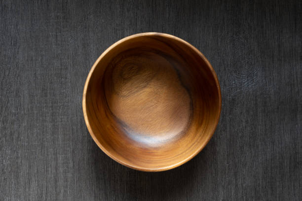 istock acacia bowl on black wooden table 1174736950