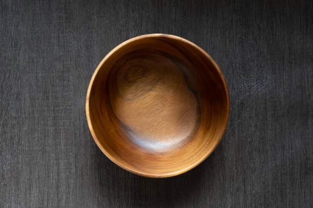 istock acacia bowl on black wooden table 1174736975