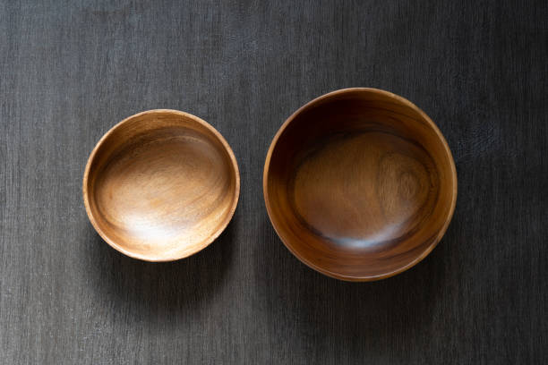 istock acacia bowl on black wooden table 1174737489