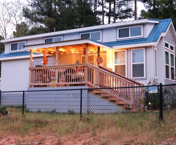 istock Blue tiny house with porch lights. 1174737499