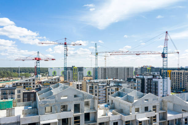 istock high building tower cranes at construction site against blue sky background 1174752856