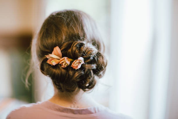 flower wreath in the hair, decoration on the head of the bride from fresh flowers, wedding day, image of the bride