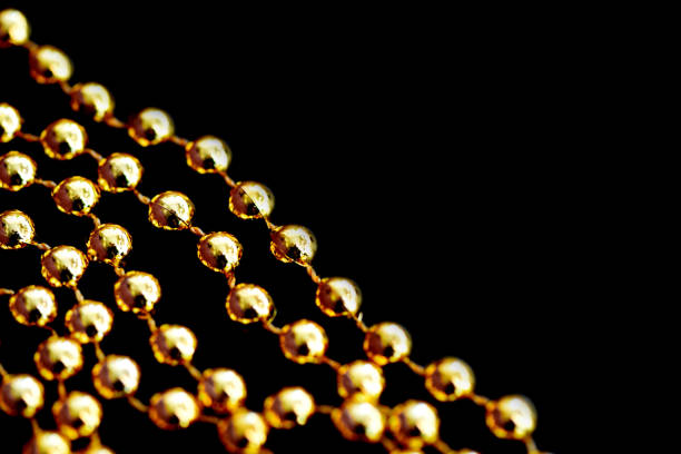 Golden christmas decoration on a dark surface close up. Abstract background