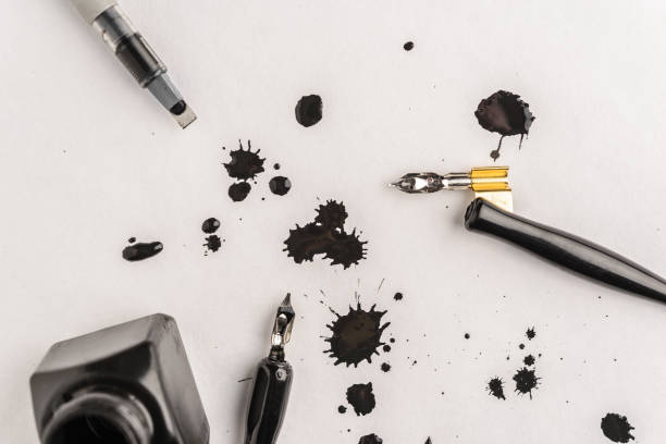 istock Calligraphy concept, pen for handwriting,spilled ink stains, brush,writing training,blank sheets of white paper , place for text 1174764564