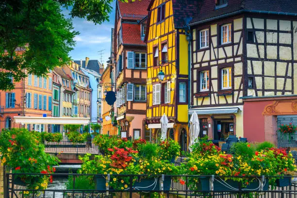 Photo of Beautiful antique half-timbered facades with decorated street, Colmar, France