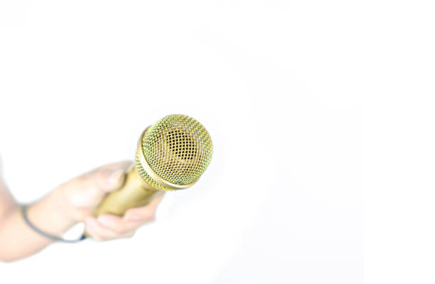Hand holding Gold microphone isolated on white Hand holding Gold microphone isolated on white interview seminar microphone inside of stock pictures, royalty-free photos & images
