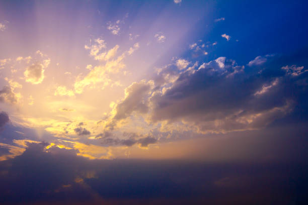 istock Sunlight rays from the clouds on a blue and purple sky 1174768090