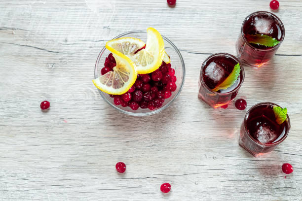 istock Red stemware shot alcoholic cold cocktail with cranberries raspberries and mint. copy space, top view. 1174768322