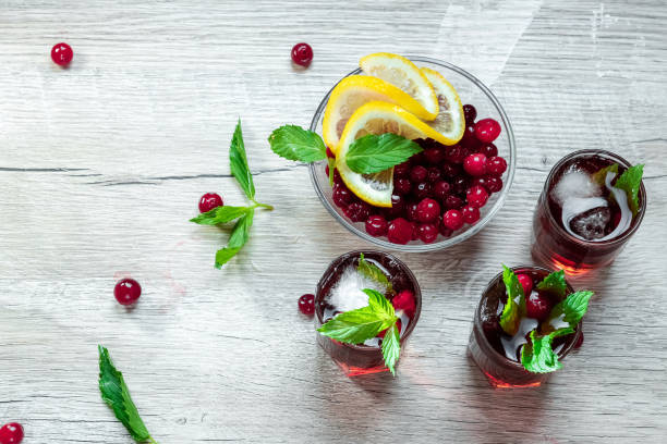 istock Red stemware shot alcoholic cold cocktail with cranberries raspberries and mint. copy space, top view. 1174768338