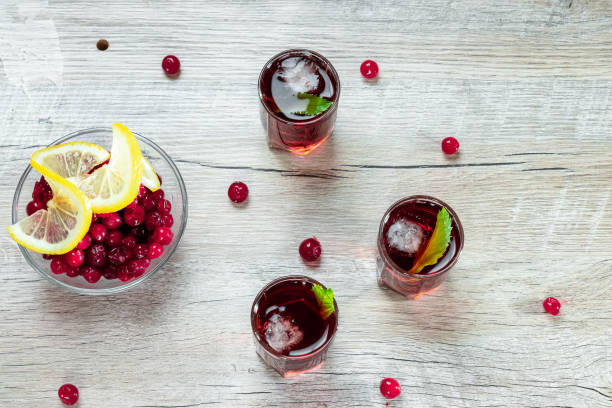 istock Red stemware shot alcoholic cold cocktail with cranberries raspberries and mint. copy space, top view. 1174768348