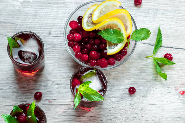 istock Red stemware shot alcoholic cold cocktail with cranberries raspberries and mint. copy space, top view. 1174768373