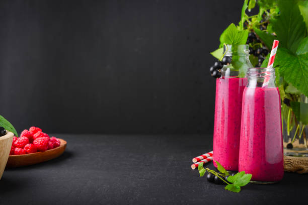 istock Raspberry and currant berry smoothie in a glass bottle with a straw and mint leaf 1174777155