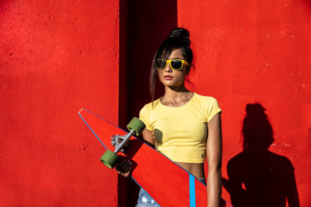 istock Woman holding scateboard 1174777195