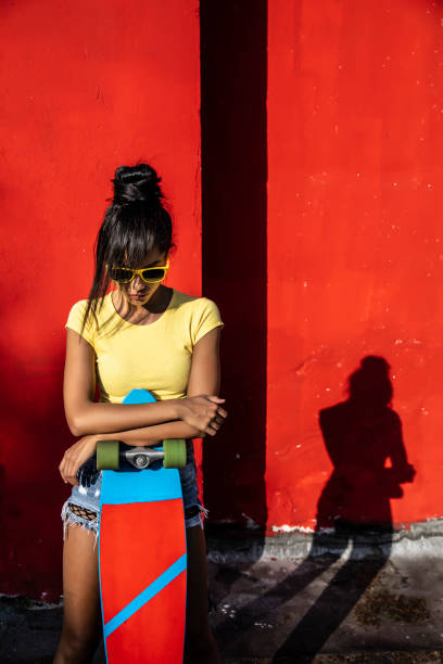 istock Woman holding scateboard 1174777220