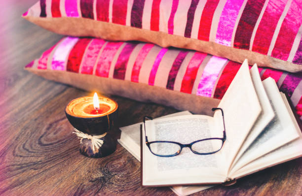 istock Burning spa aroma candles in coconut shell and  burgundy pillows with pattern, cozy home interior background 1174777428