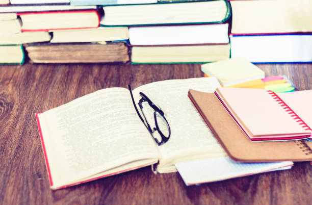 istock Books background, open book and glasses on wooden table in office for education learning concept 1174777665