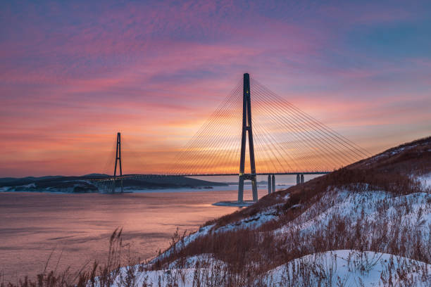Winter sunset view with fresh snow and long cable-stayed bridge in Vladivostok