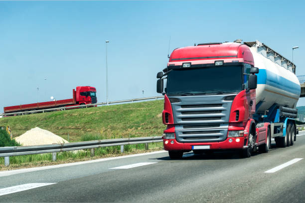 istock Truck on country highway under blue sky 1174782043