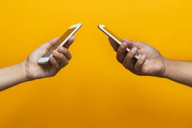 istock Two Hands Holding Mobile Phones 1174782045